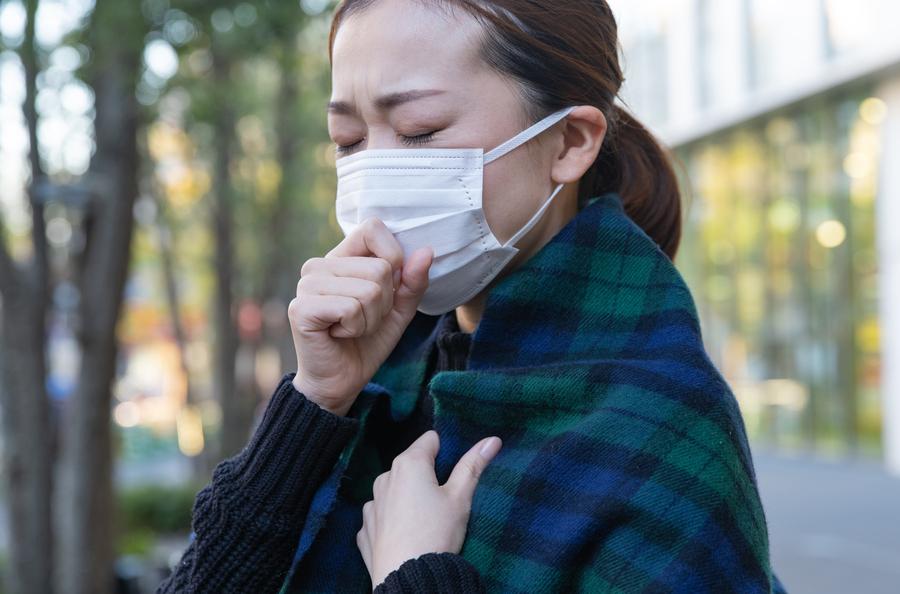咳込むマスク姿の女性